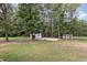 Spacious backyard with a basketball court, shed, and storage for outdoor activities and relaxation at 604 S Chavis St, Franklinton, NC 27525