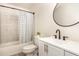 Nicely updated bathroom featuring a modern sink, vanity, and tiled shower at 604 S Chavis St, Franklinton, NC 27525