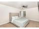 Comfortable bedroom with a plush headboard, natural light, and a ceiling fan at 604 S Chavis St, Franklinton, NC 27525