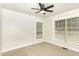 This is a bedroom with carpeting, two windows, and a ceiling fan at 604 S Chavis St, Franklinton, NC 27525