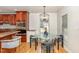Bright dining area with a contemporary chandelier, a glass table, and views of the backyard at 604 S Chavis St, Franklinton, NC 27525