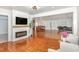 Open concept living room featuring modern fireplace and mantle and a view of the kitchen and dining area at 604 S Chavis St, Franklinton, NC 27525