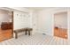 Mud room featuring stylish black-and-white floors, bench and plenty of space for storage at 604 S Chavis St, Franklinton, NC 27525