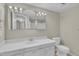 Bright bathroom with dual mirrors, vanity with ample storage, and a tiled floor at 612 Pine Ridge Pl, Raleigh, NC 27609