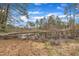 Picturesque lake view showcasing natural beauty, a fallen tree, and surrounding lush foliage at 612 Pine Ridge Pl, Raleigh, NC 27609