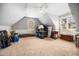 Large attic space featuring sloped ceilings and a carpeted floor, perfect for storage at 7001 Millstone Ridge Ct, Raleigh, NC 27614
