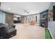 Spacious finished basement with barn doors, fireplace, mini putt-putt course, and lounge area at 7001 Millstone Ridge Ct, Raleigh, NC 27614