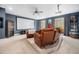 Home theater with recliner seating, projector and screen for immersive entertainment in the finished basement at 7001 Millstone Ridge Ct, Raleigh, NC 27614