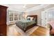 Serene bedroom with a large window, tray ceiling, and a cozy bed at 7001 Millstone Ridge Ct, Raleigh, NC 27614