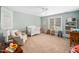 Neutral Bedroom with natural light, featuring crib, rocking chair, and neutral carpet at 7001 Millstone Ridge Ct, Raleigh, NC 27614