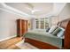 Comfortable bedroom featuring a large window, stylish ceiling fan, and ample storage with its wooden wardrobe at 7001 Millstone Ridge Ct, Raleigh, NC 27614