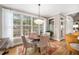 Bright breakfast nook with table and chairs, large windows with backyard view, and hardwood floors at 7001 Millstone Ridge Ct, Raleigh, NC 27614