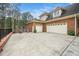 Brick home featuring a spacious driveway and three car garage, perfect for car enthusiasts at 7001 Millstone Ridge Ct, Raleigh, NC 27614