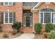 Inviting front entrance with brick steps, lush landscaping, and decorative wreath at 7001 Millstone Ridge Ct, Raleigh, NC 27614