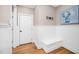 Entryway with white trim, bench seating, coat hooks, and an art piece hanging on the wall at 7001 Millstone Ridge Ct, Raleigh, NC 27614