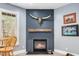 Stylish fireplace with a wooden mantle and a decorative bull skull above at 7001 Millstone Ridge Ct, Raleigh, NC 27614
