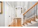 Bright foyer featuring hardwood floors, a staircase, and an arched entryway at 7001 Millstone Ridge Ct, Raleigh, NC 27614