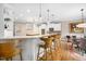 Open concept kitchen features bar seating, white cabinets, granite counters, and stainless steel appliances at 7001 Millstone Ridge Ct, Raleigh, NC 27614