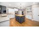 Well-appointed kitchen featuring white cabinets, stainless steel appliances, and an island with a butcher block countertop at 7001 Millstone Ridge Ct, Raleigh, NC 27614