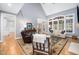 Well-lit living room with hardwood floors, comfortable seating, and large windows providing plenty of natural light at 7001 Millstone Ridge Ct, Raleigh, NC 27614
