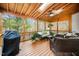 Covered outdoor living space featuring wood ceiling and comfortable wicker seating at 7001 Millstone Ridge Ct, Raleigh, NC 27614