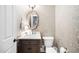 Stylish powder room with decorative wallpaper, vanity, and modern fixtures at 7001 Millstone Ridge Ct, Raleigh, NC 27614