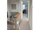 A well lit second story hallway with carpeted floor and entry into a bedroom at 704 Martin Luther King Jr Blvd # D12, Chapel Hill, NC 27514