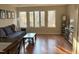 Bright and spacious living room with large windows and hardwood floors at 704 Martin Luther King Jr Blvd # D12, Chapel Hill, NC 27514
