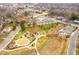 An aerial view of community features a playground, walking paths, a creek, and community gathering building at 712 Tarleton Ave, Burlington, NC 27215