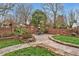 Secluded backyard featuring a stone patio, lush garden, and brick privacy wall, ideal for outdoor relaxation at 712 Tarleton Ave, Burlington, NC 27215