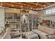 Basement wine cellar featuring custom shelving for wine storage and a seating area with overhead string lights at 712 Tarleton Ave, Burlington, NC 27215