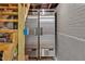 Basement area featuring commercial style double refrigerators next to wooden stairs and a painted concrete wall at 712 Tarleton Ave, Burlington, NC 27215