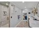 Bright bathroom with white marble shower, walk-in closet, double sink vanity with bronze fixtures and herringbone floors at 712 Tarleton Ave, Burlington, NC 27215