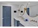 Contemporary bathroom with a double sink vanity, quartz countertops, bronze fixtures, subway tile backsplash, and a blue door at 712 Tarleton Ave, Burlington, NC 27215