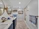 Modern bathroom featuring double sinks, quartz countertops, herringbone floors, bronze fixtures, and a glass shower at 712 Tarleton Ave, Burlington, NC 27215