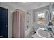 Traditional bathroom with a black and white checkered floor, a shower with a striped curtain and a blue door at 712 Tarleton Ave, Burlington, NC 27215