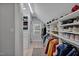 This is a walk-in closet with custom shelving, hardwood floors, a window and clothing racks at 712 Tarleton Ave, Burlington, NC 27215