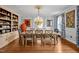 Elegant dining room with hardwood floors, stylish chandelier, and built-in shelving for sophisticated entertaining at 712 Tarleton Ave, Burlington, NC 27215