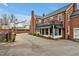 A beautiful brick home with a wrought iron balcony, covered patio, and large driveway on a sunny day at 712 Tarleton Ave, Burlington, NC 27215