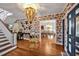 Elegant foyer with hardwood floors, chandelier, and view into the dining room at 712 Tarleton Ave, Burlington, NC 27215