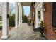 Inviting front porch with stone flooring, rocking chair, and classic decor at 712 Tarleton Ave, Burlington, NC 27215