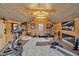 This is a gym with wood paneled walls, exercise equipment, and a gas fireplace at 712 Tarleton Ave, Burlington, NC 27215