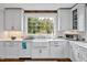 Updated kitchen featuring shaker cabinets, stainless steel appliances, and a bright window view at 712 Tarleton Ave, Burlington, NC 27215