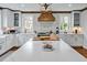 Well-appointed kitchen with a center island, chef's appliances, and custom range hood at 712 Tarleton Ave, Burlington, NC 27215