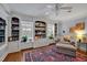 Cozy living room featuring custom built-ins, a ceiling fan, and comfortable chaise lounge with bright, decorative rug at 712 Tarleton Ave, Burlington, NC 27215