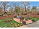 Charming brick patio with elegant outdoor furniture and manicured landscaping, creating a private and inviting retreat at 712 Tarleton Ave, Burlington, NC 27215