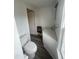 Compact bathroom featuring a toilet, vanity, and a well-lit mirror and modern luxury vinyl plank flooring at 804 S Sampson Ave, Dunn, NC 28334