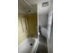 Full bathroom with a shower-tub combo, white fixtures, and modern luxury vinyl plank flooring at 804 S Sampson Ave, Dunn, NC 28334