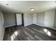 Bedroom featuring neutral paint, new floors, ceiling light, and two door-accessed closets at 804 S Sampson Ave, Dunn, NC 28334