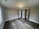 Bedroom featuring neutral paint, new floors, ceiling light, and large closet at 804 S Sampson Ave, Dunn, NC 28334